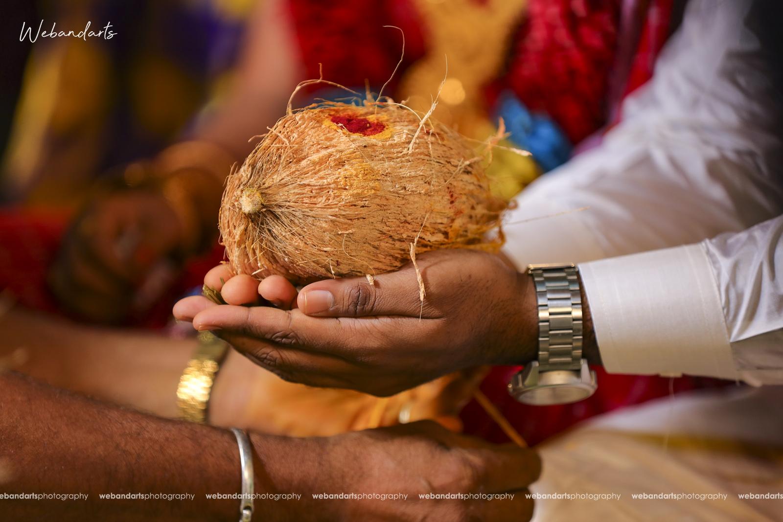 hindu-wedding-south-indian-rituals-coconut-couple-hands_1110